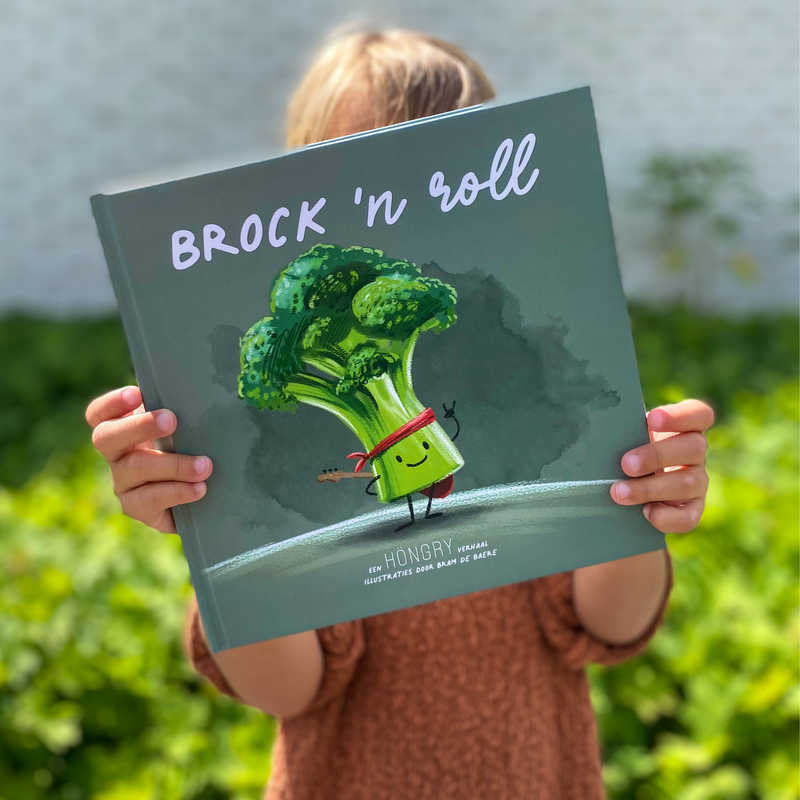 Kindje die HONGRY lees boek Brock 'n roll met Freddie Broccoli voor zicht vasthoudt.